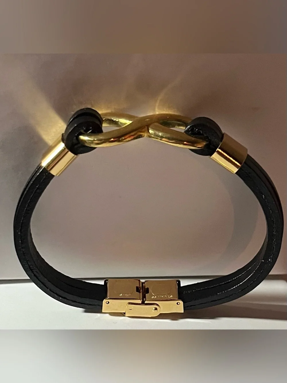 Black Faux Leather Bracelet with Gold tone Infinity Link, and hardware. (NWOT)